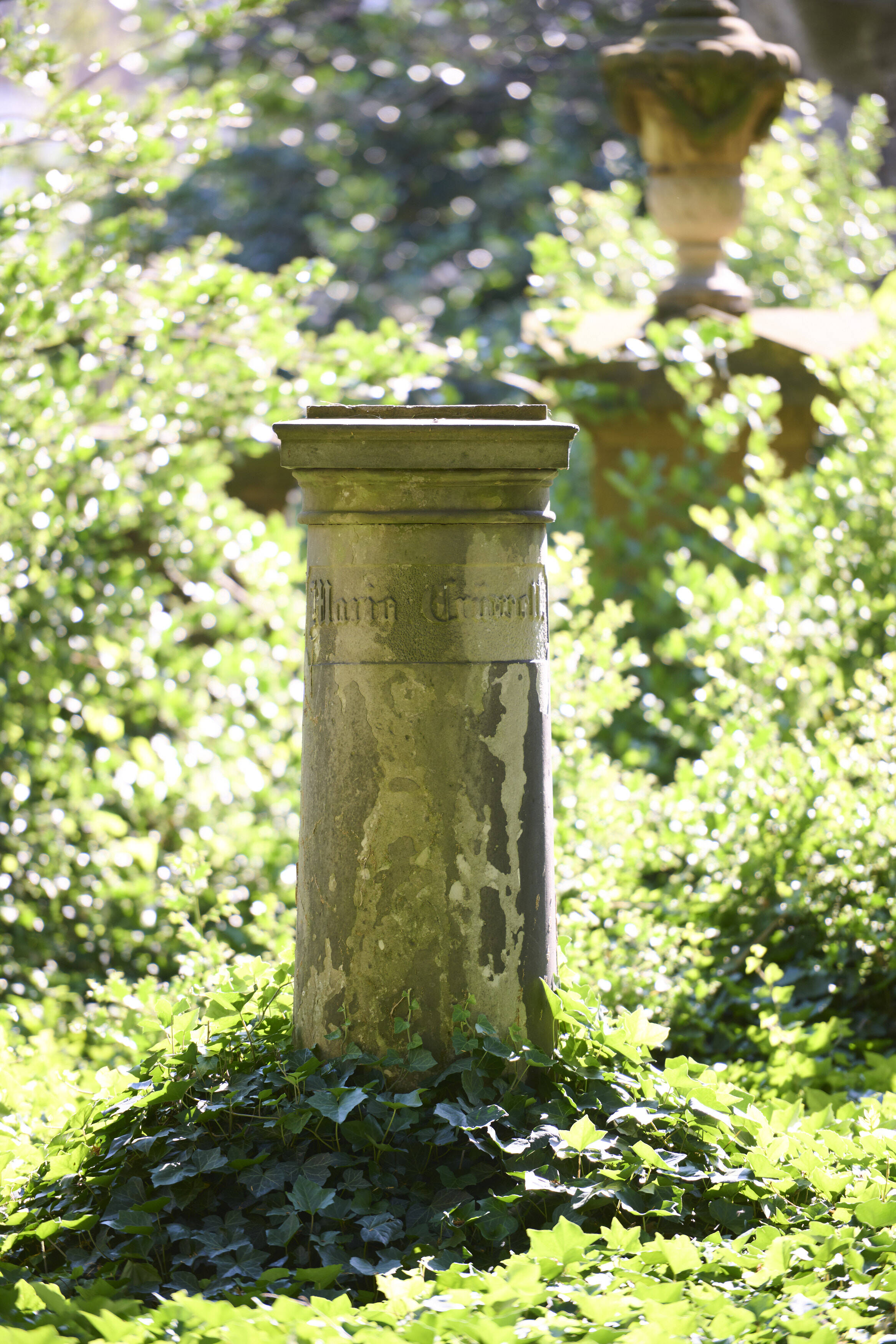 Bildtitel - Grabstätte von Maria Crüwell: Eine Sandsteinsäule mit oben abgeflachtem Abschluss, auf der früher eine Marmorbüste der Verstorbenen thronte.